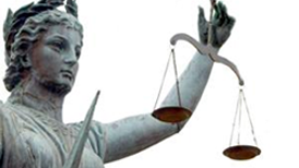 photo of statue of justice holding scales